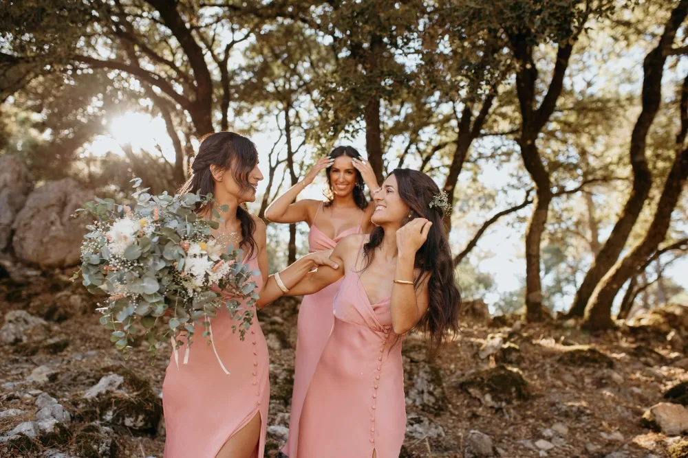 Invitée de mariage portant une tenue élégante bleu pâle avec accessoires raffinés, dans un décor de réception fleuri.